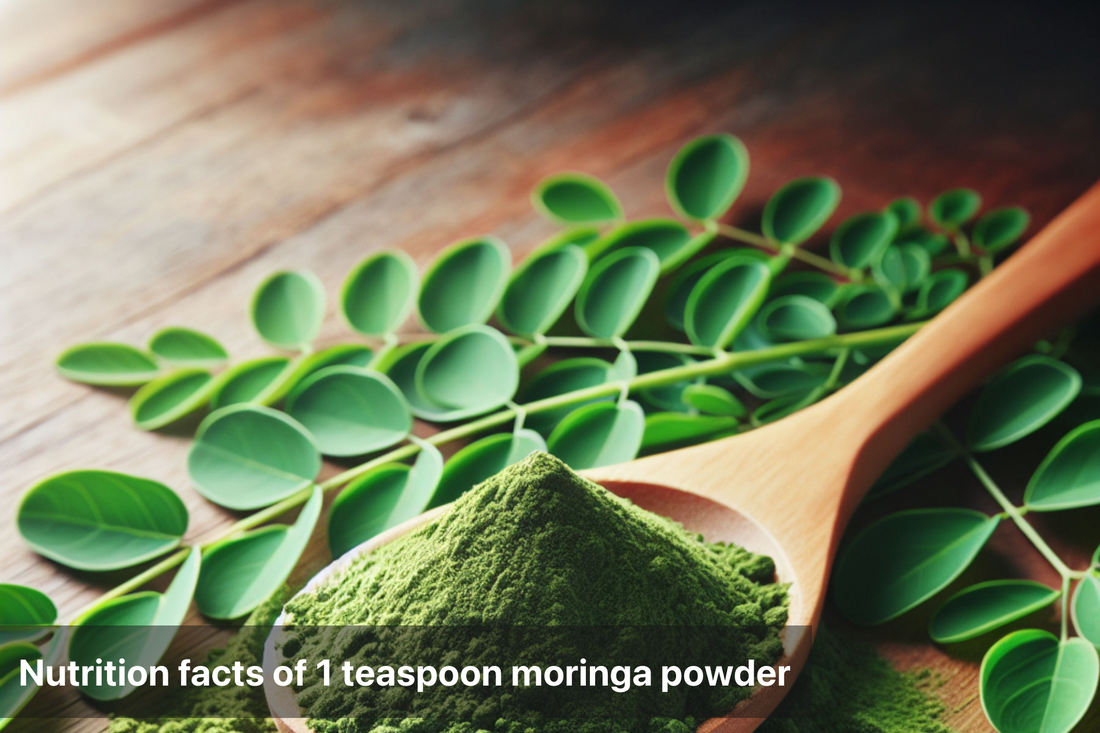 Moringa powder in a wooden spoon with fresh leaves